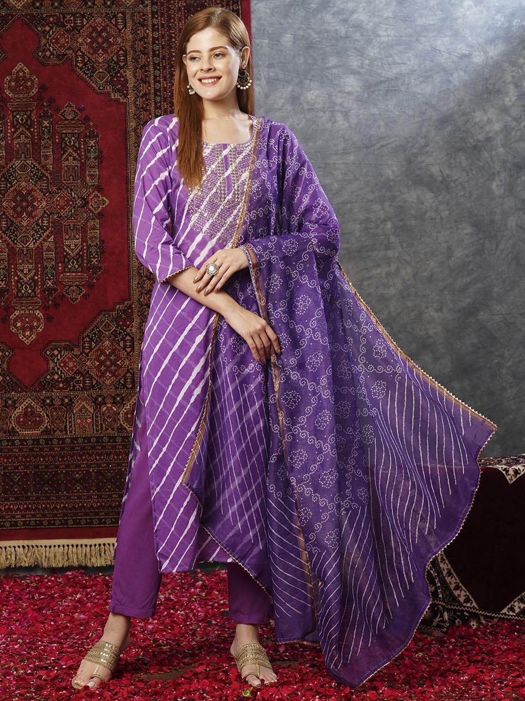 

Anni Designer Leheriya Embroidered Mirror Work Kurta With Trousers & Dupatta, Purple