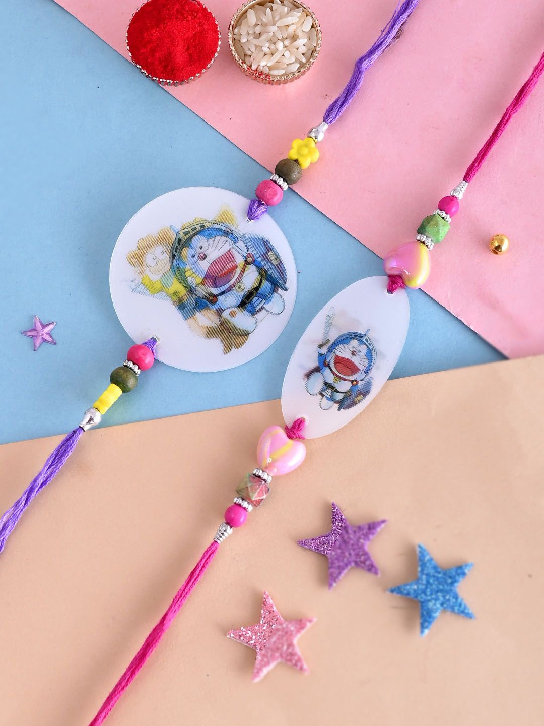 

Aapno Rajasthan Set of 2 Doreamon Beaded Rakhis With Roli Chawal, Blue