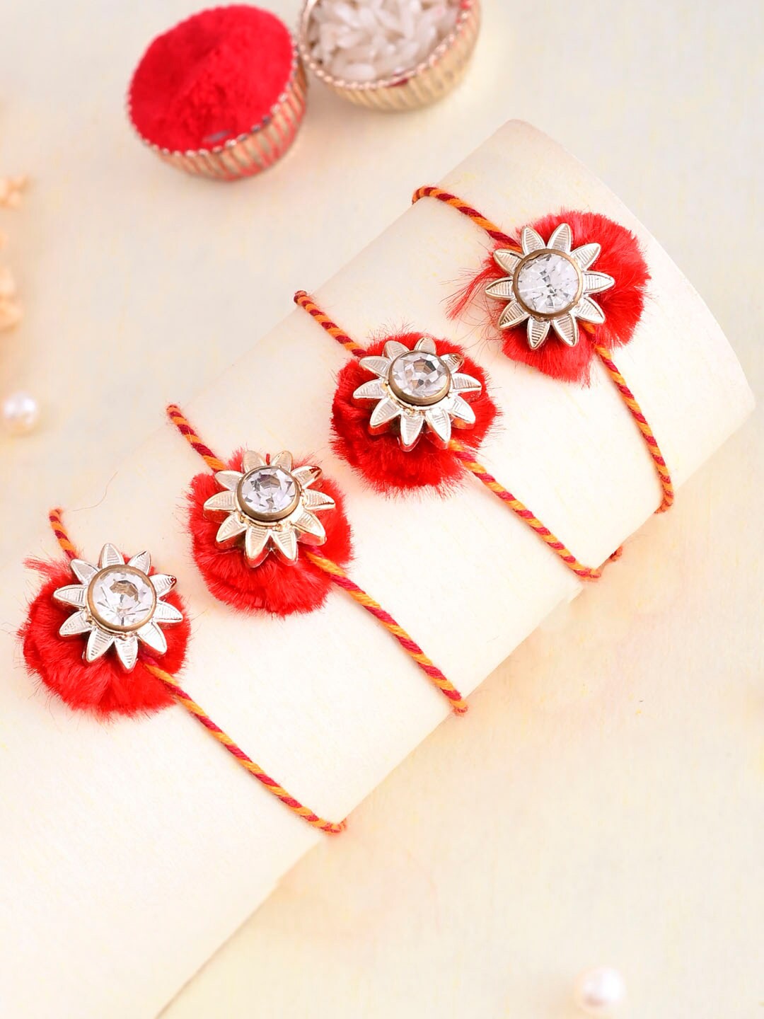 

Aapno Rajasthan Set of 5 Beaded Thread Rakhis with Greetings Card & Roli Chawal, Red