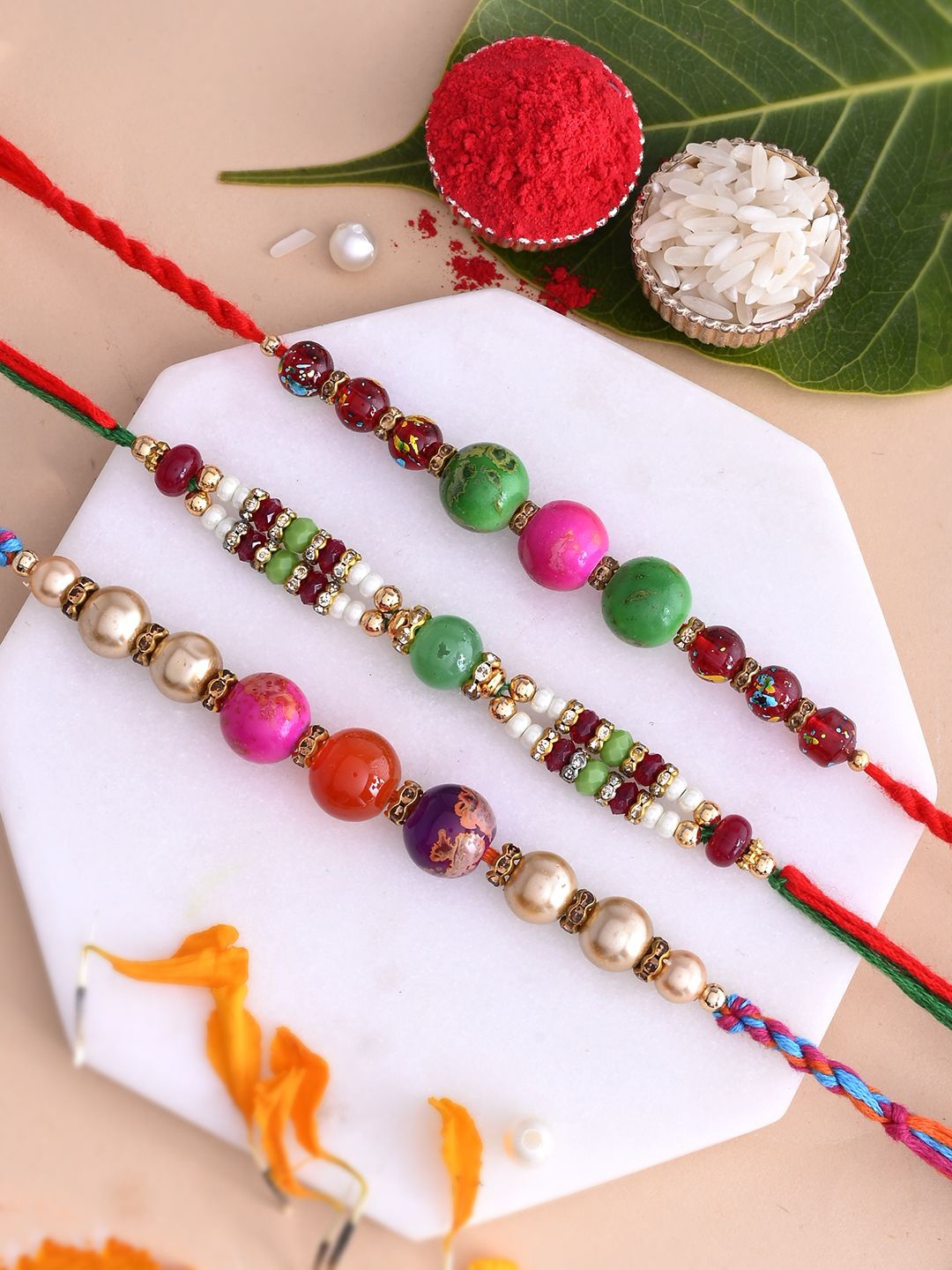 

Aapno Rajasthan Set Of 3 Stone Studded & Beaded Rakhis With Roli Chawal & Greetings Card, Green