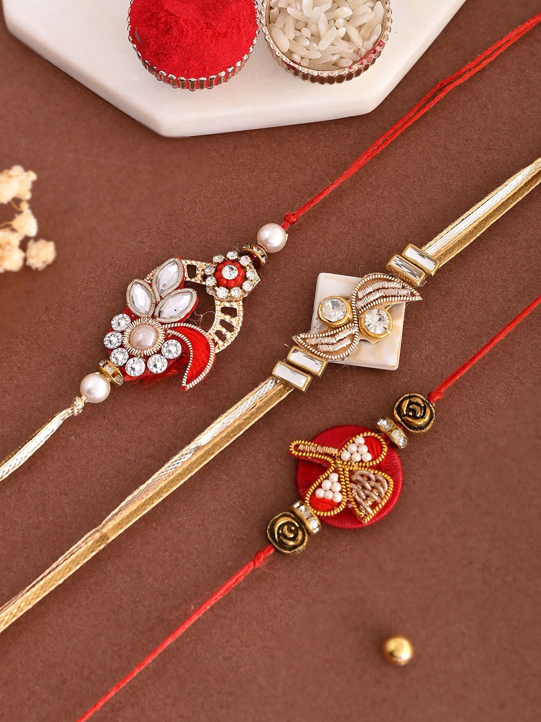 

Aapno Rajasthan Set Of 3 Stone Studded & Beaded Bhaiya Bhabhi Rakhis With Roli Chawal, Gold