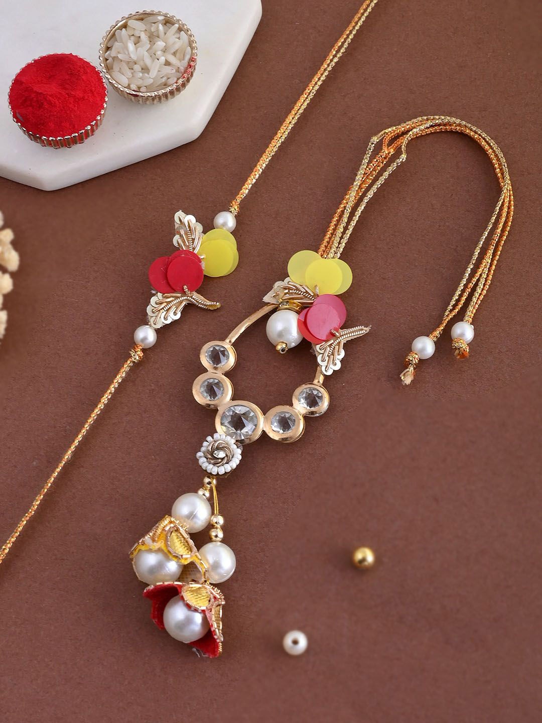 

Aapno Rajasthan Stones & Beaded Bhaiya Bhabhi Rakhis With Roli Chawal & Greetings Card, Gold