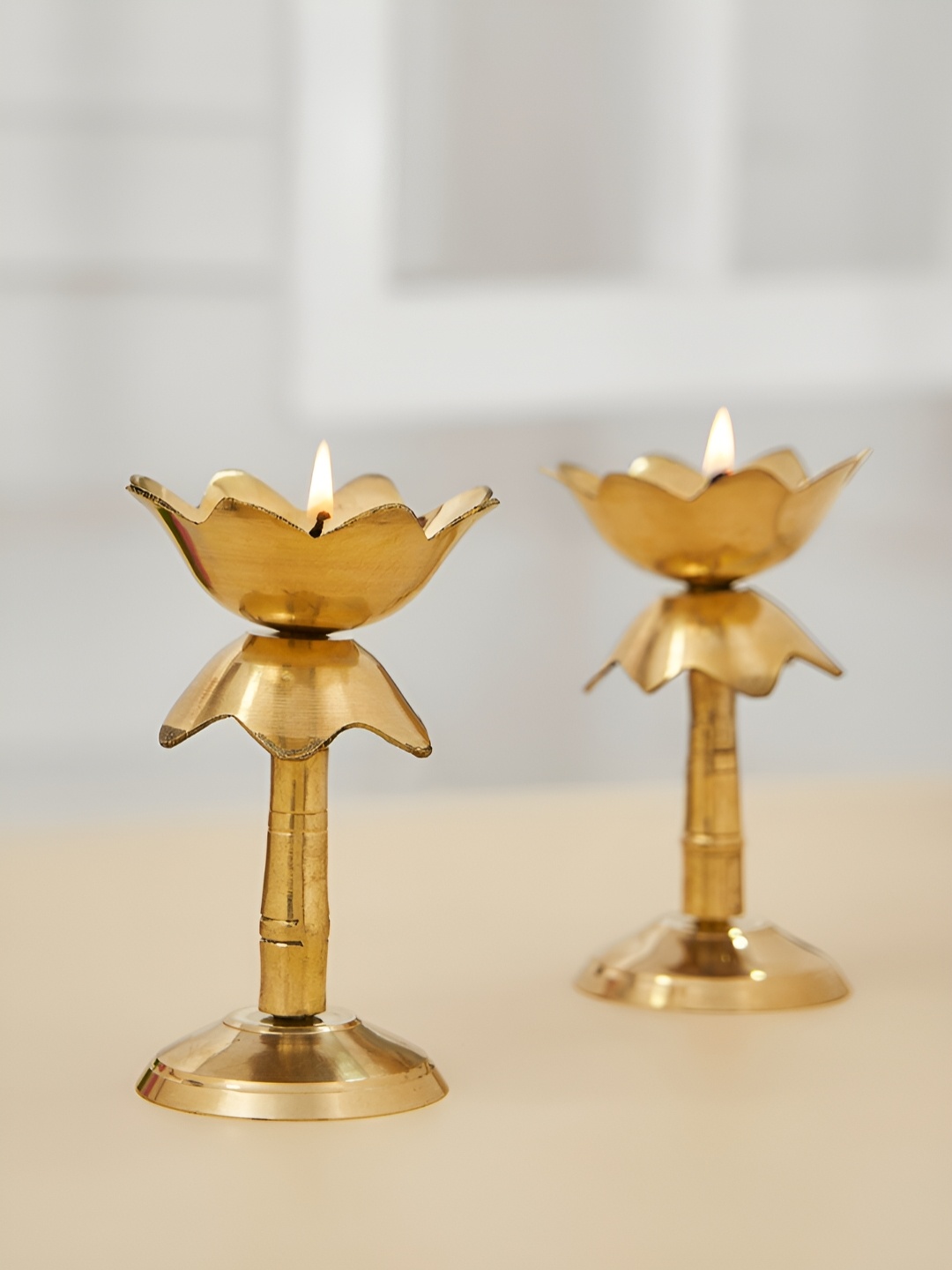 

DecorTwist Gold toned 2 Pieces Lotus Shape Pillar Diya Stand
