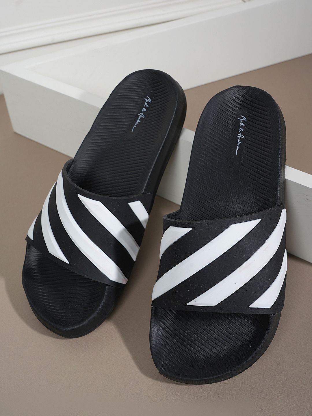 

Mast & Harbour Men Black Striped Rubber Sliders