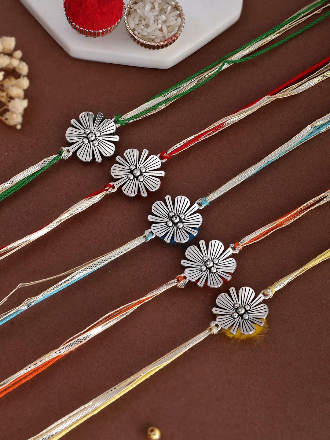 

Aapno Rajasthan Set of 5 Floral Thread Rakhis with Greetings Card & Roli Chawal, Silver