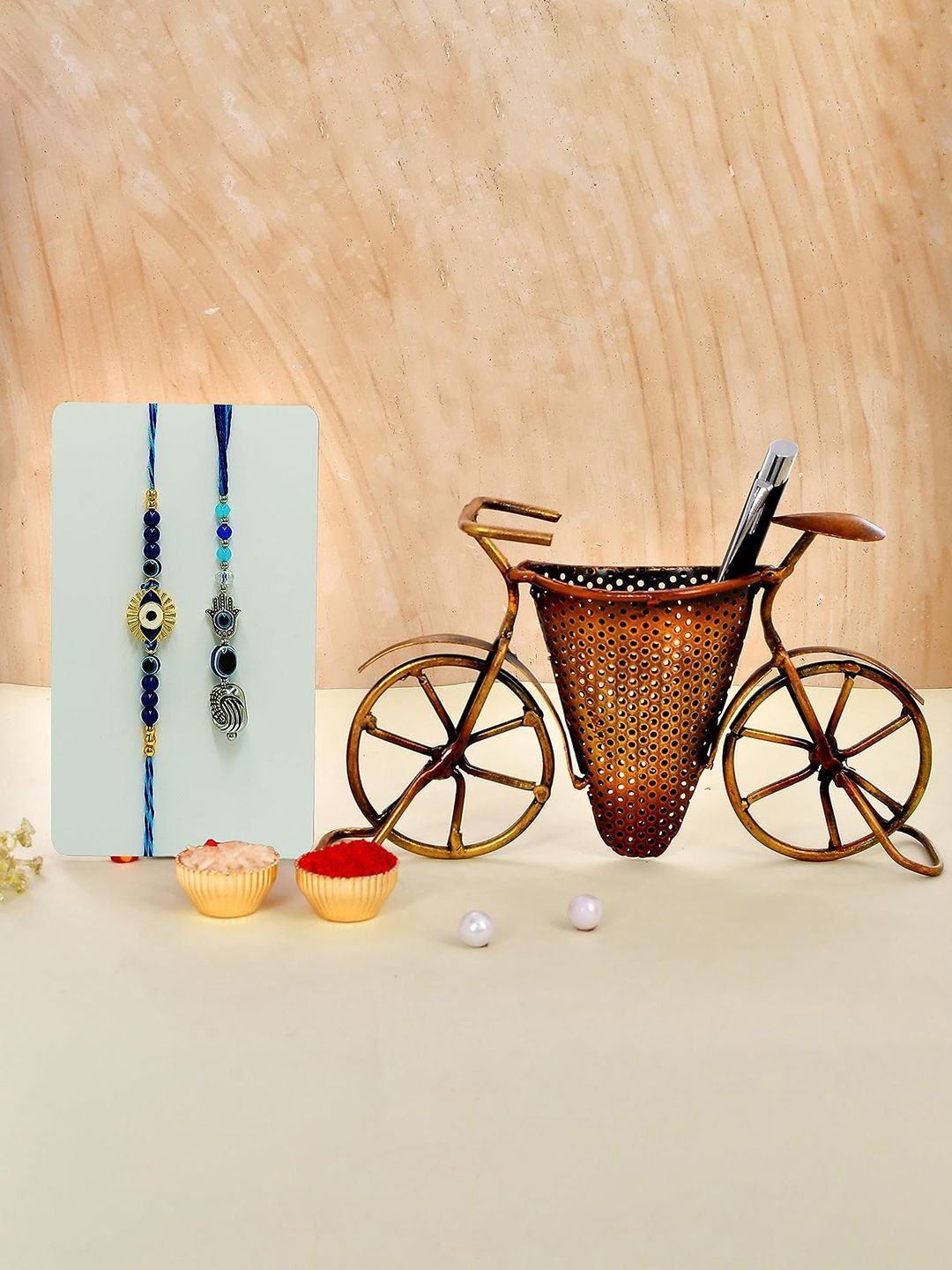 

CraftVatika Set Of 3 Evil Eye Charm Rakhi With Cycle Penstand Roli Chawal, Multi