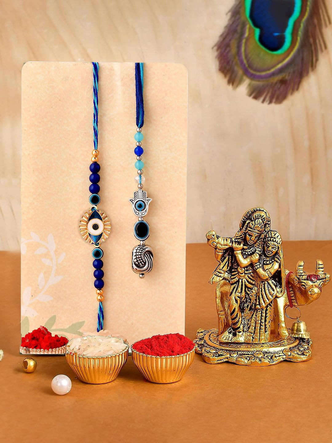 

CraftVatika Set Of 3 Evil Eye Rakhis With Radha Krishna Idol & Roli Chawal, Blue