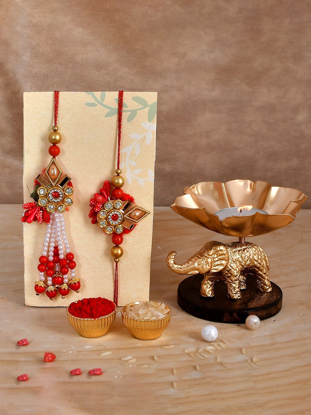 

CraftVatika Set Of 3 Rakhis with Elephant Candle Holder With Roli Chawal, Red