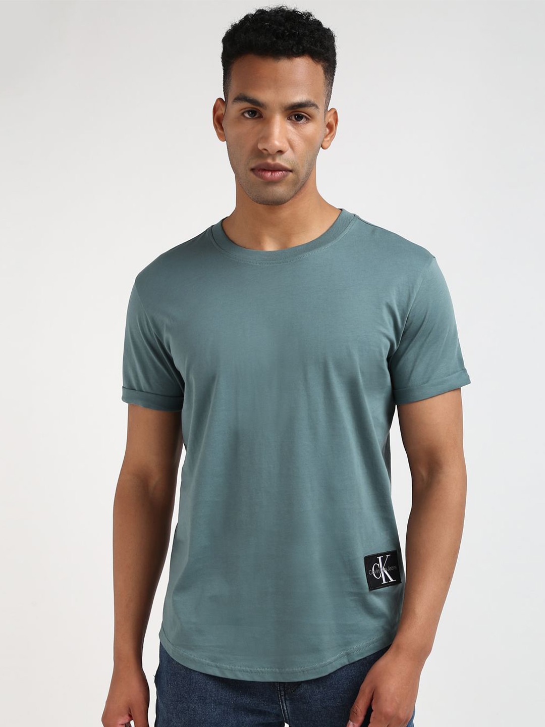 

Calvin Klein Jeans Men Solid Round Neck Applique Cotton T-shirt, Teal