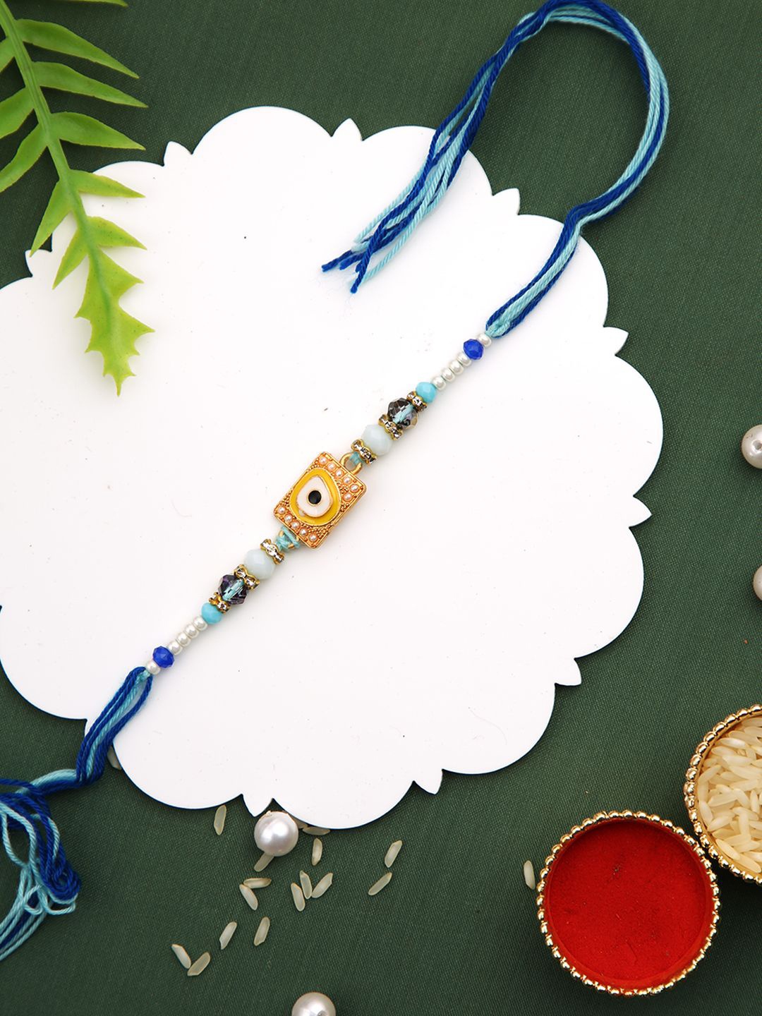 

Aapno Rajasthan Beaded Evil Eye Thread Rakhi With Roli Chawal & Greetings Card, Blue