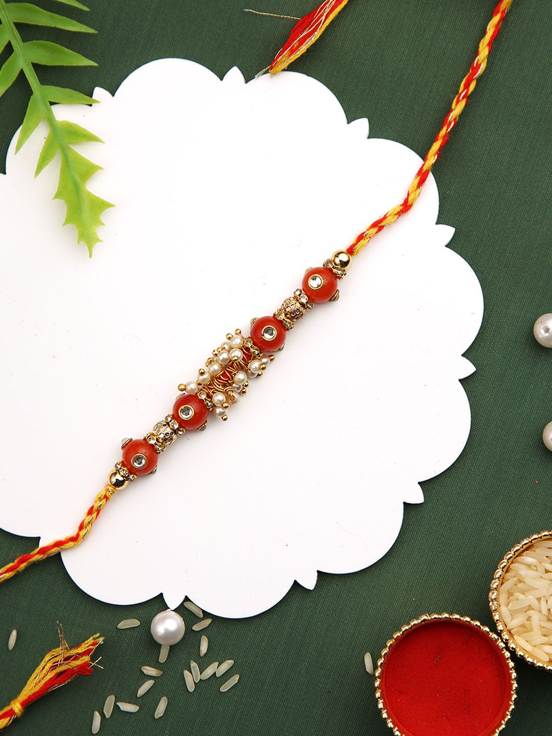 

Aapno Rajasthan Beaded Mauli Thread Rakhi With Roli Chawal & Greetings Card, Gold