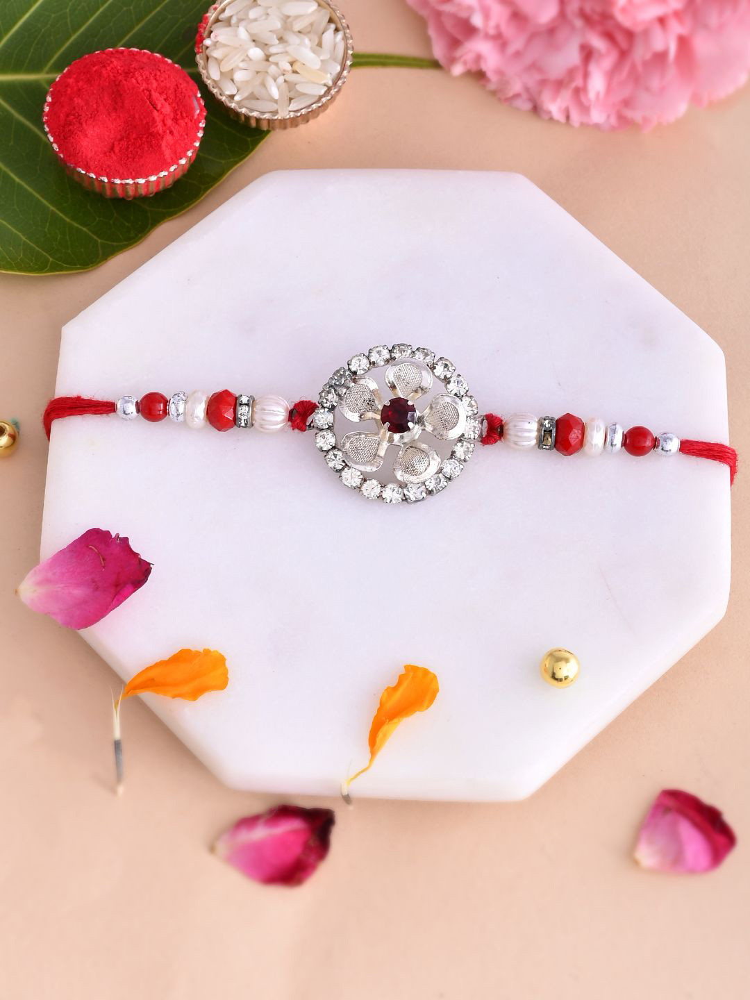 

Aapno Rajasthan AD Studded Petals Floral Rakhi With Roli Chawal & Greetings Card, Red