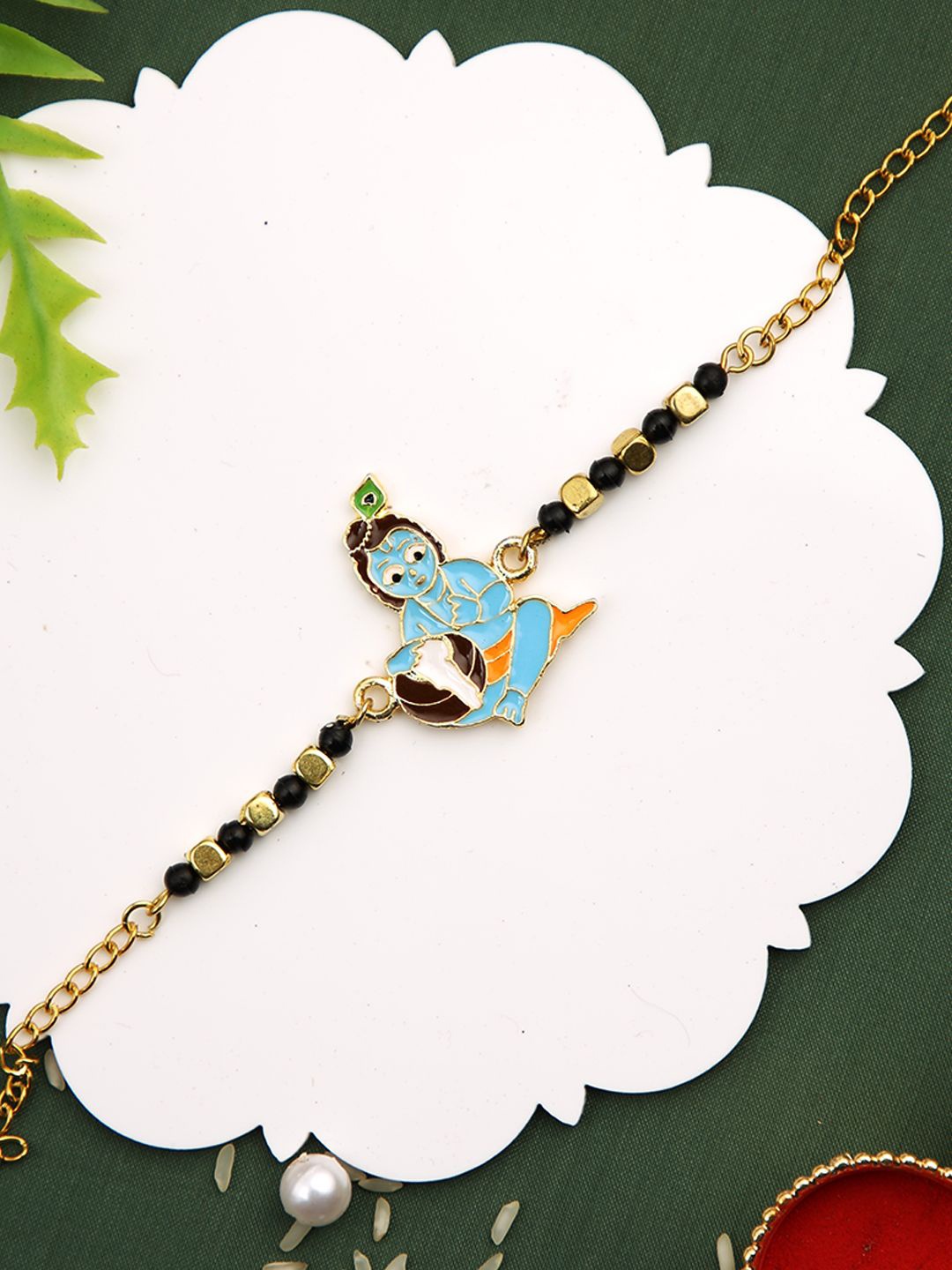 

Aapno Rajasthan Beaded Shri Krishna Divine Rakhi With Roli Chawal & Greetings Card, Green