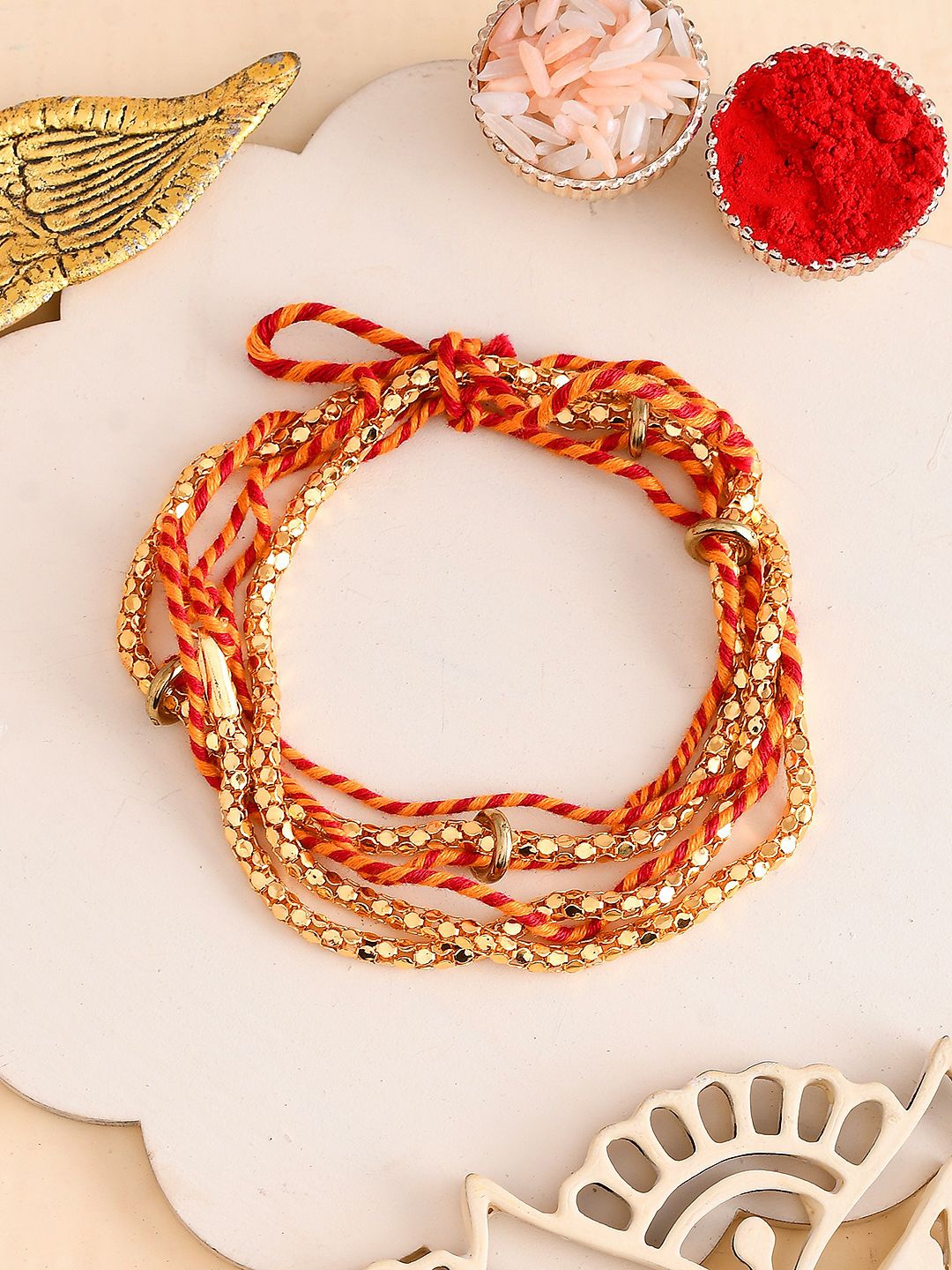 

Aapno Rajasthan Twisted Ring Mauli Thread Rakhi With Roli Chawal & Greetings Card, Gold