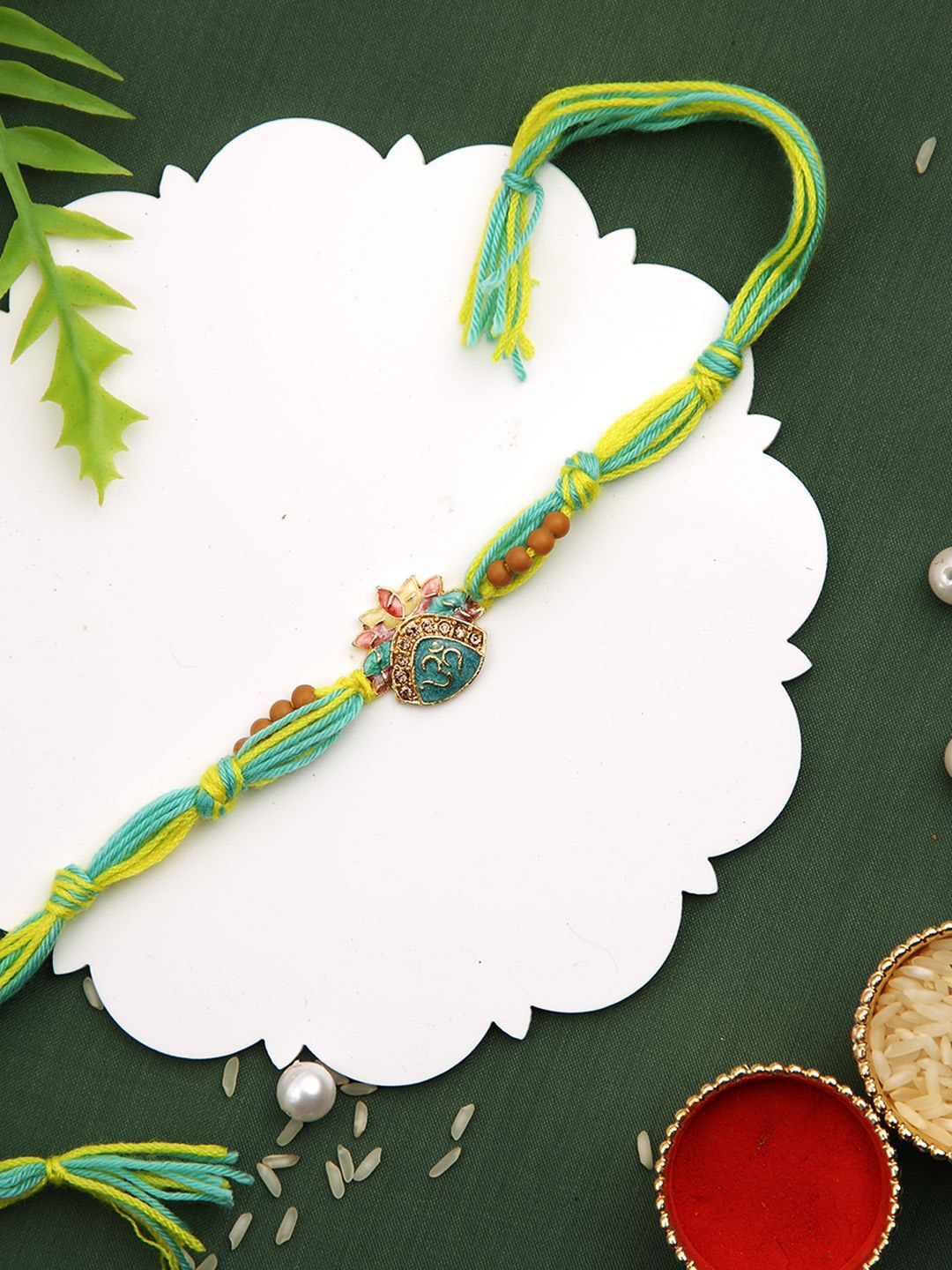 

Aapno Rajasthan Beaded Thread Rakhi with Greetings Card & Roli Chawal, Yellow