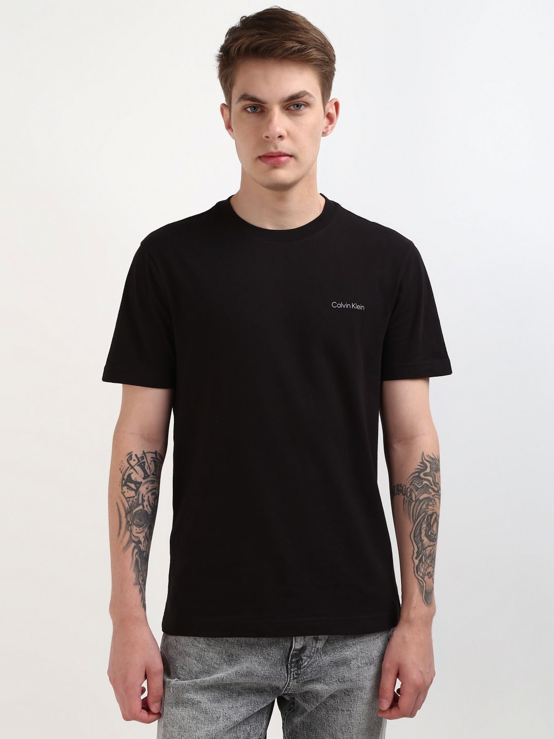 

Calvin Klein Jeans Men Solid Round Neck Cotton T-Shirt, Black