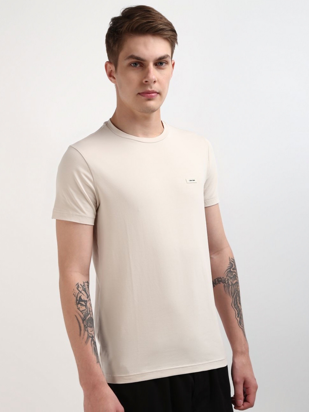 

Calvin Klein Jeans Men Solid Round Neck Cotton Slim Fit T-Shirt, Beige