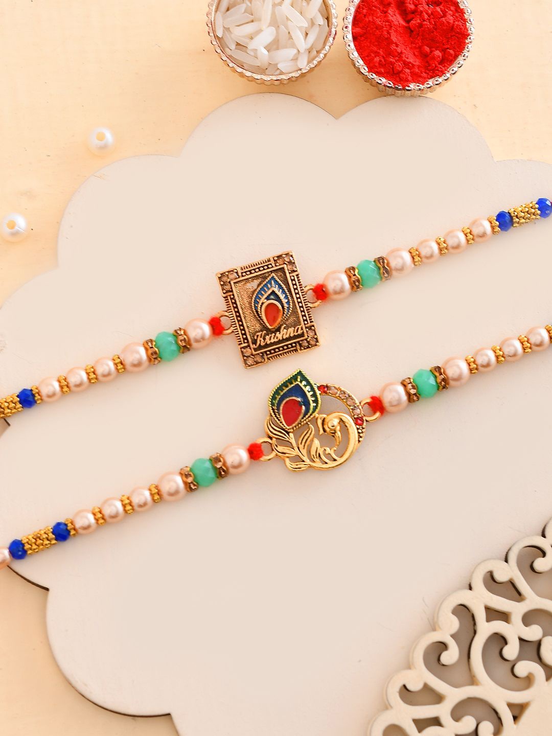 

Aapno Rajasthan Set of 2 Beaded Thread Rakhis with Roli Chawal & Greetings Card, Gold