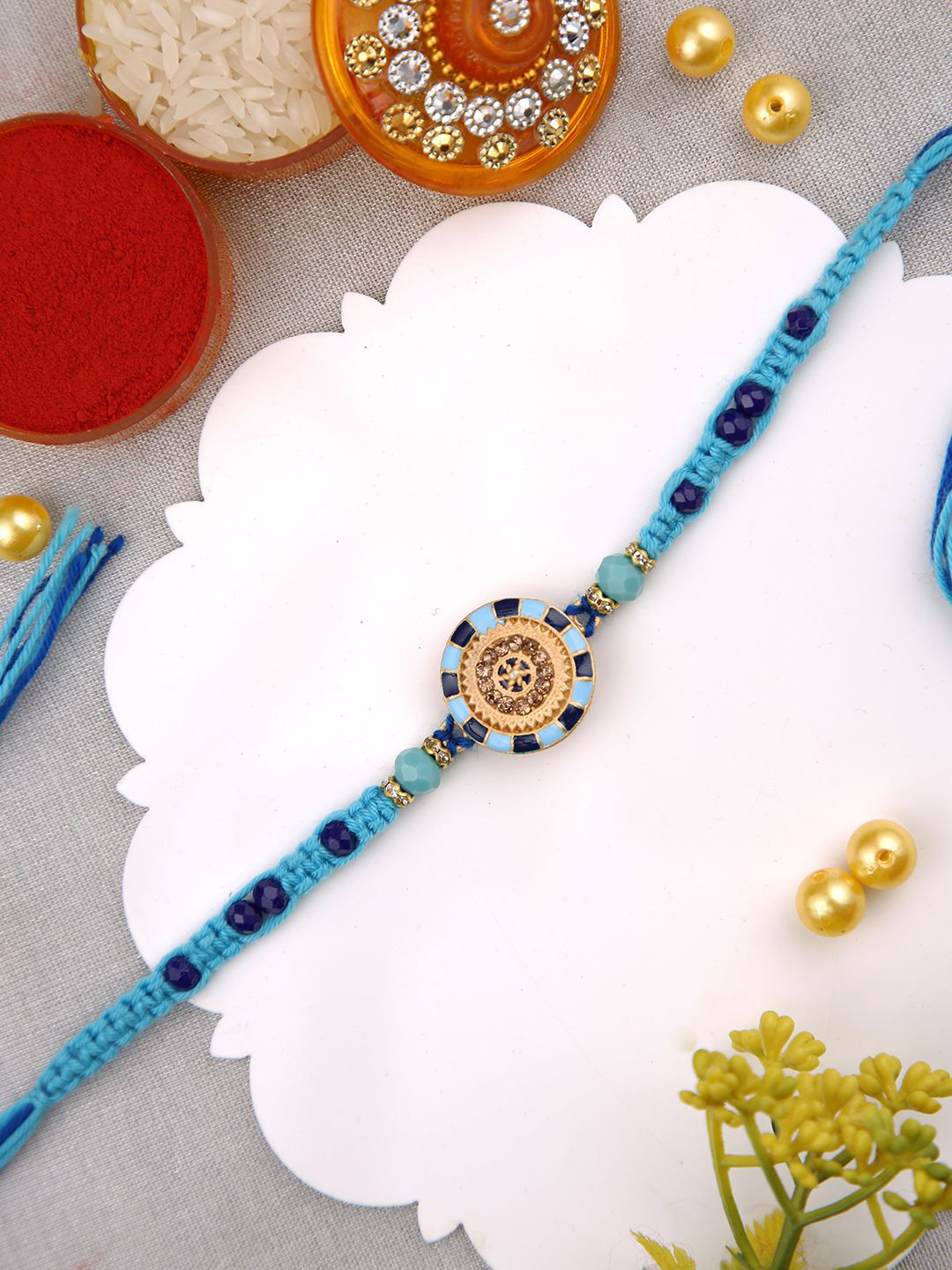 

Aapno Rajasthan Stone Studded & Beaded Thread Rakhi With Roli Chawal & Greeting Card, Gold