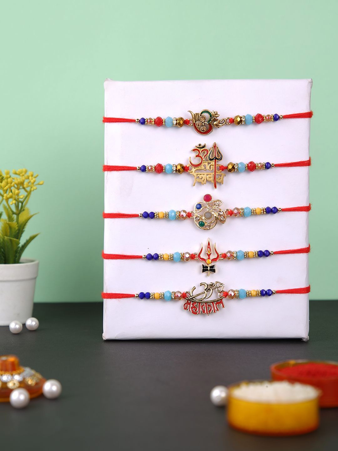 

Aapno Rajasthan Set of 5 Om and Shiva Beaded Rakhi with Roli Chawal, Red