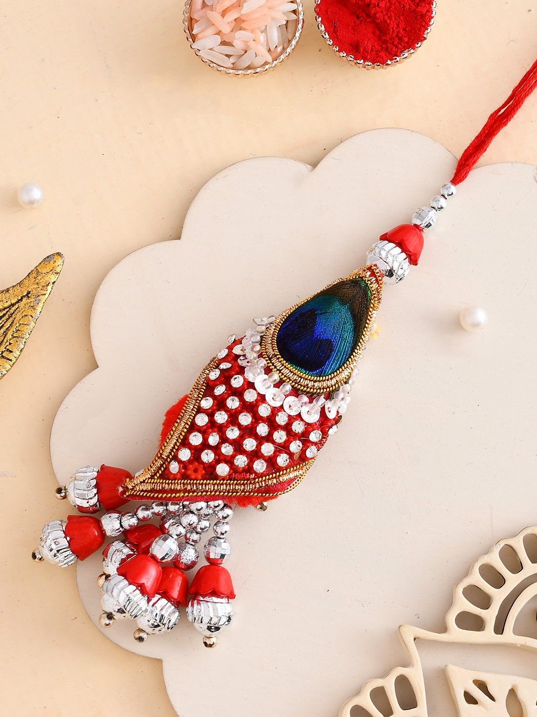 

Aapno Rajasthan Peacock Feather Lumba Rakhi, Red