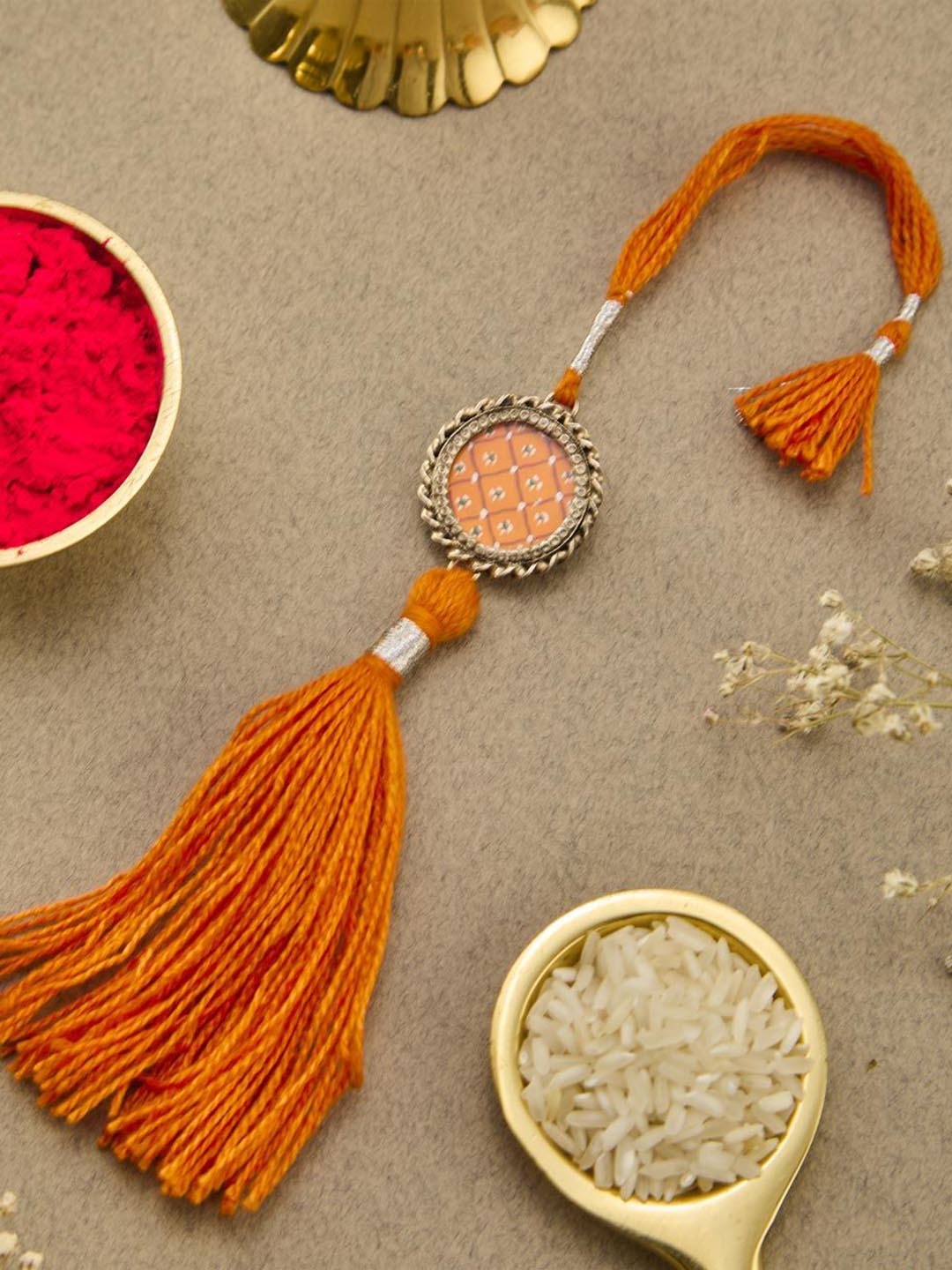 

Fabindia Thread Rakhi With Roli Chawal, Orange