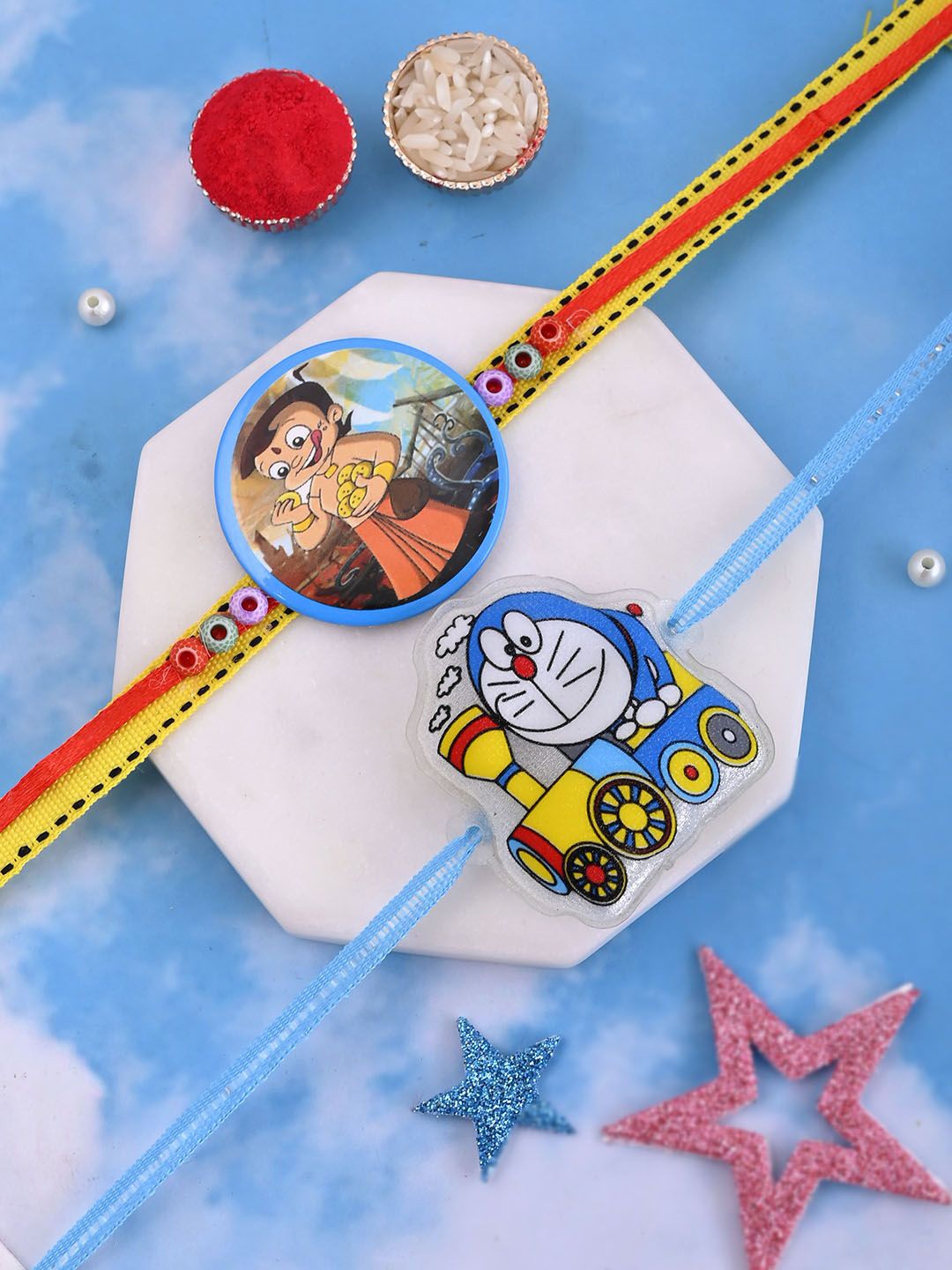 

Aapno Rajasthan Kids Set Of 2 Chota Bheem & Doraemon Thread Rakhis, Blue