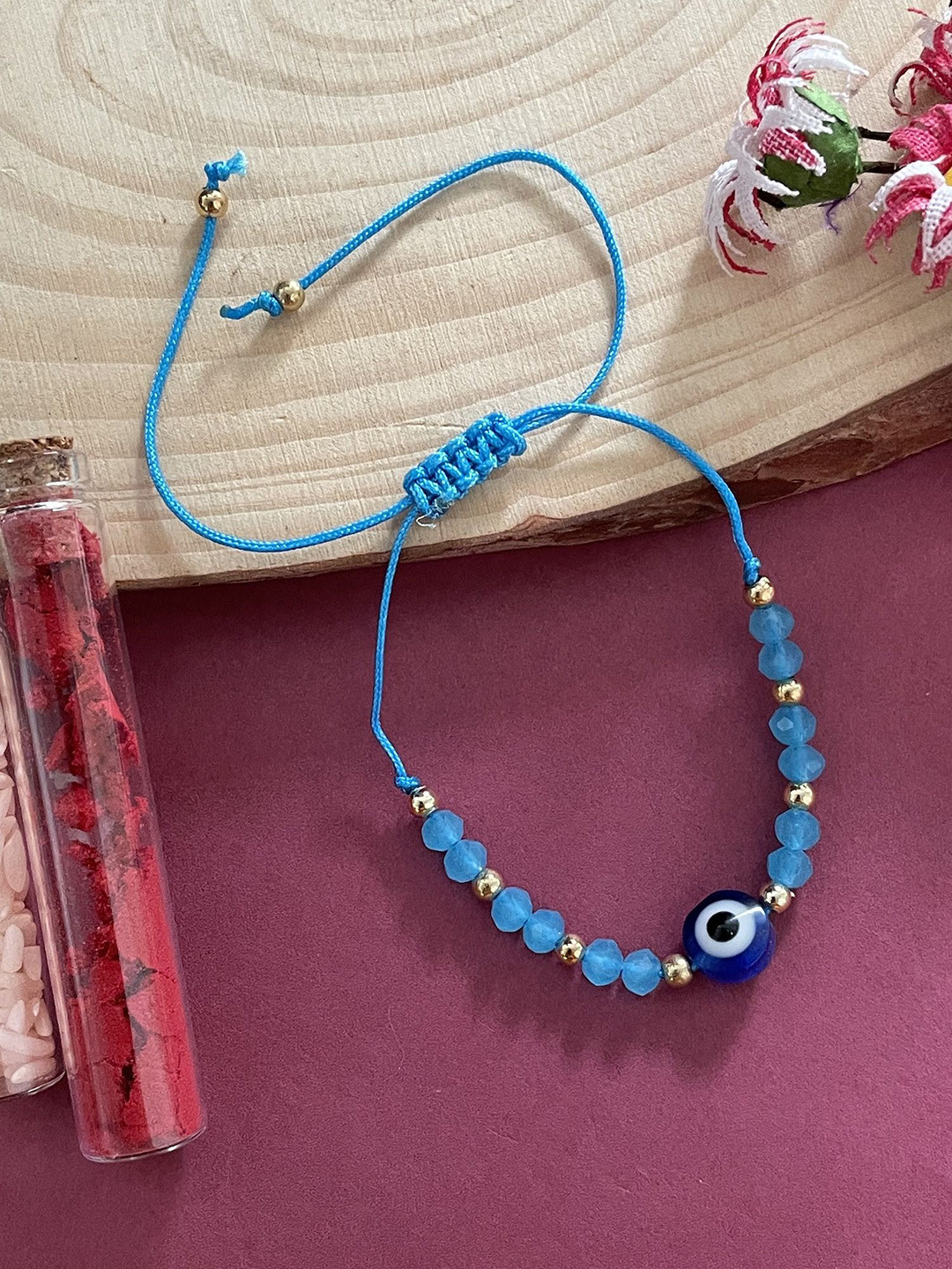 

Digital Dress Room Thread & Beaded Rakhi With Drawstring, Blue