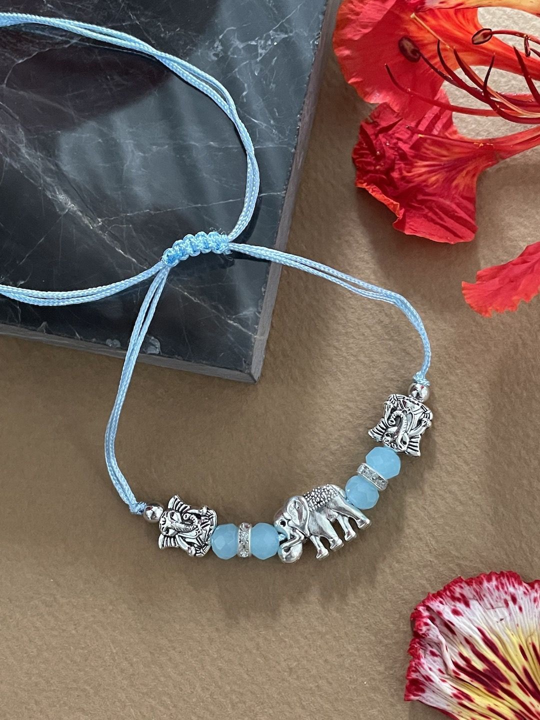 

Digital Dress Room Thread & Beaded Rakhi With Tie-Ups, Blue