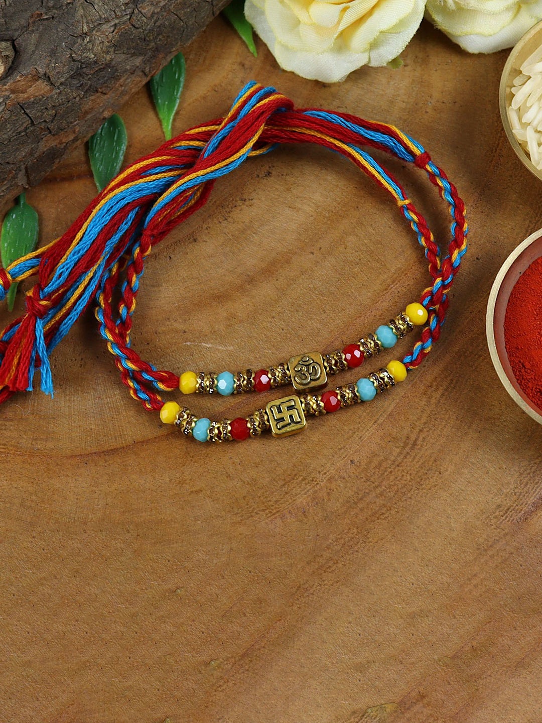 

Asthetika Set Of 2 Om Swastik Crystal Thread Rakhis With Roli Chawal, Blue