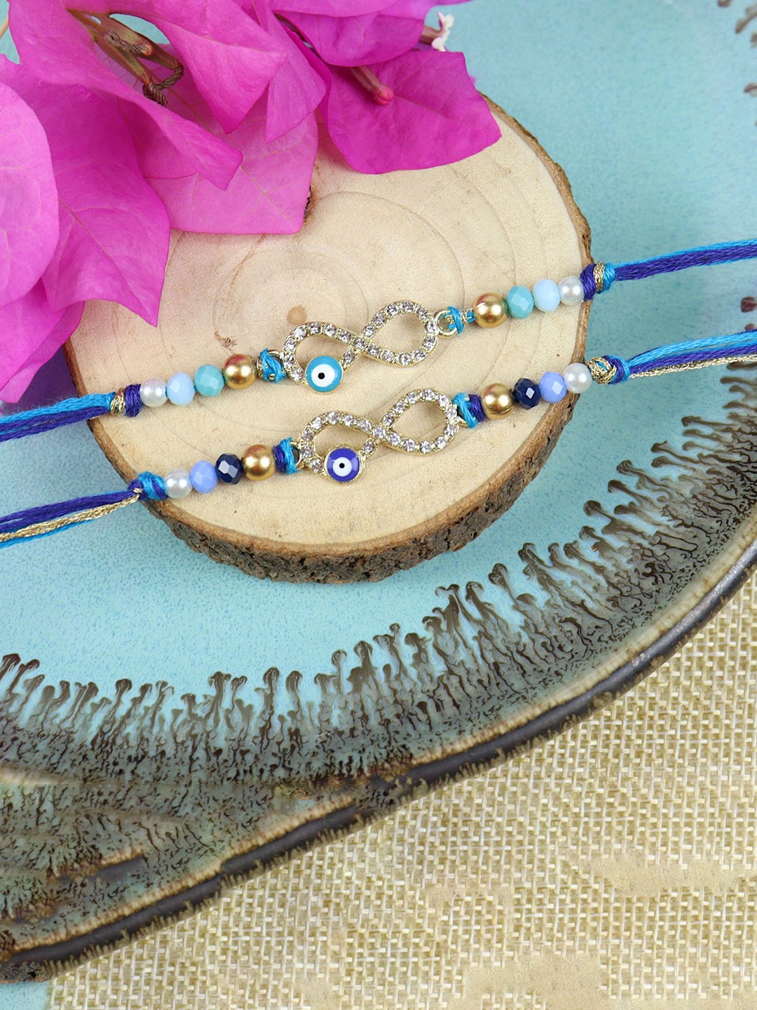 

Asthetika Set Of 2 Stone Studded Evil Eye Inifinity Thread Rakhis With Roli Chawal, Blue