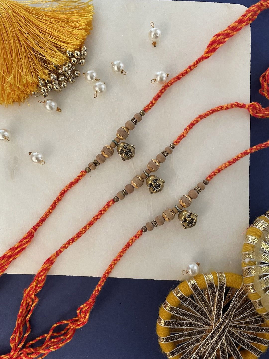 

Digital Dress Room Set Of 3 Buddha Thread Rakhi, Red