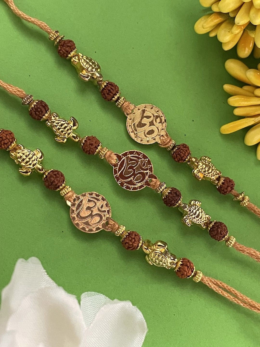 

Digital Dress Room Set Of 3 Om Tortoise Rudhraksha Thread Rakhi, Brown