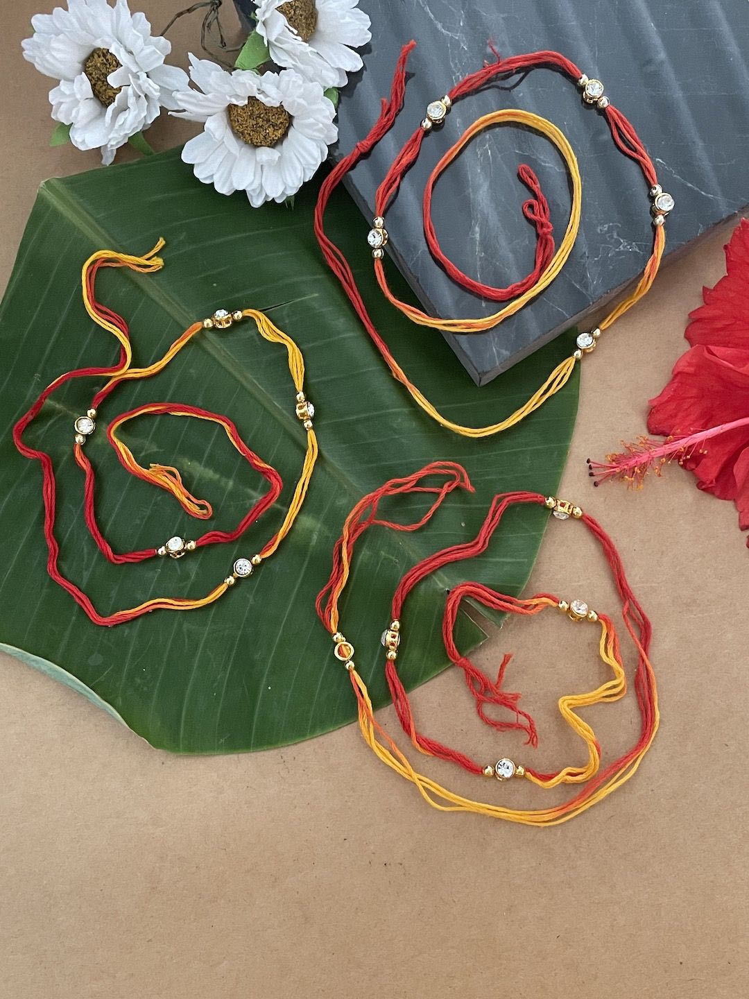

Digital Dress Room Set Of 3 Beaded Thread Rakhis With Roli Chawal, Red