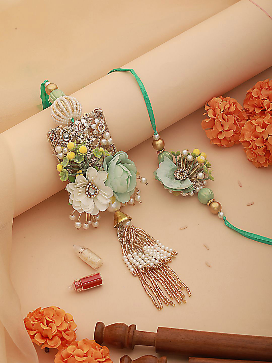 

Jazz and Sizzle Floral Work & Crystal Tasselled Bhaiya Bhabhi Rakhi With Roli & Chawal, Green