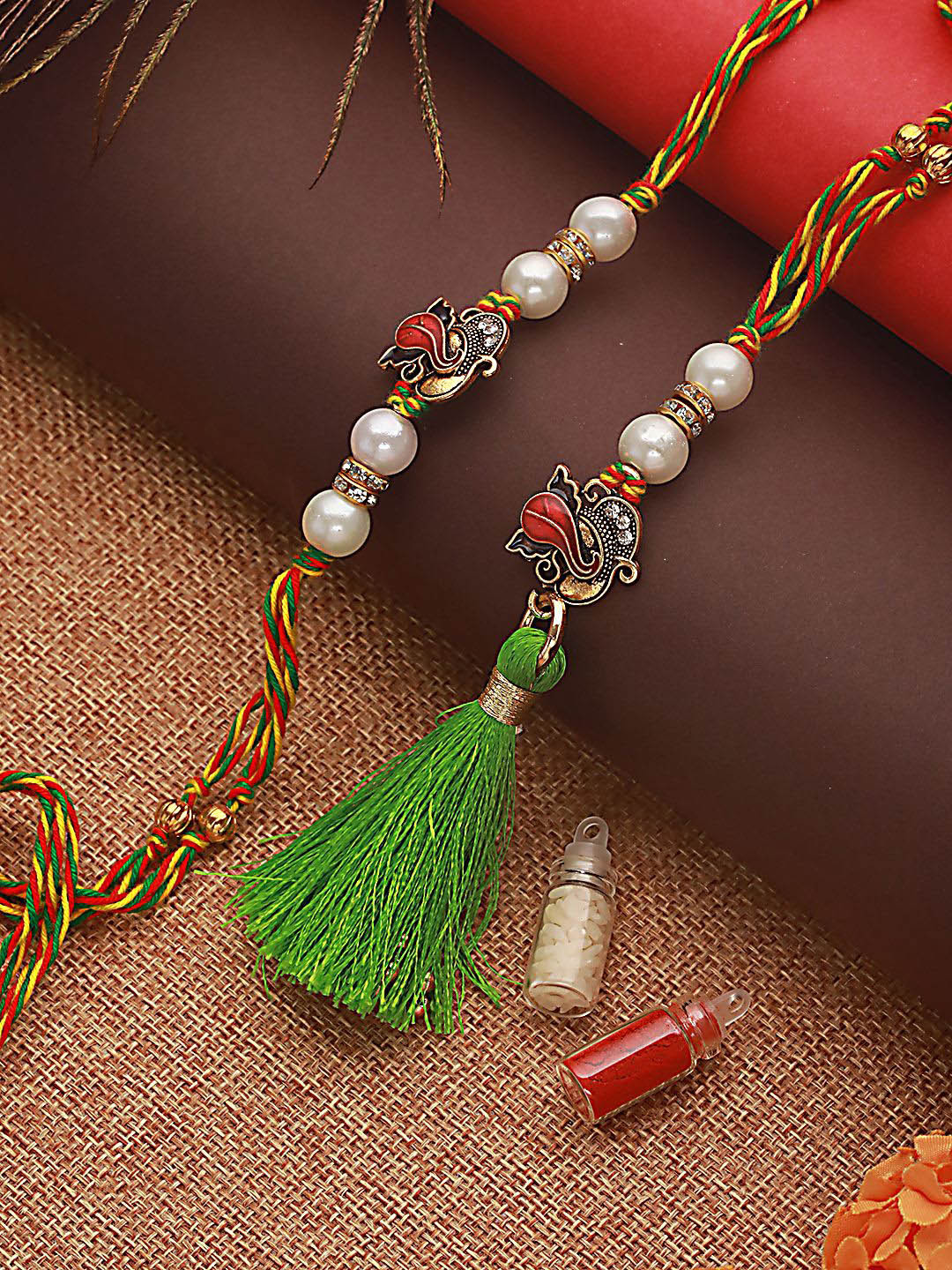 

Jazz and Sizzle Lord Ganesha Bhaiya Bhabhi Tasselled Rakhi With Roli & Chawal, Green