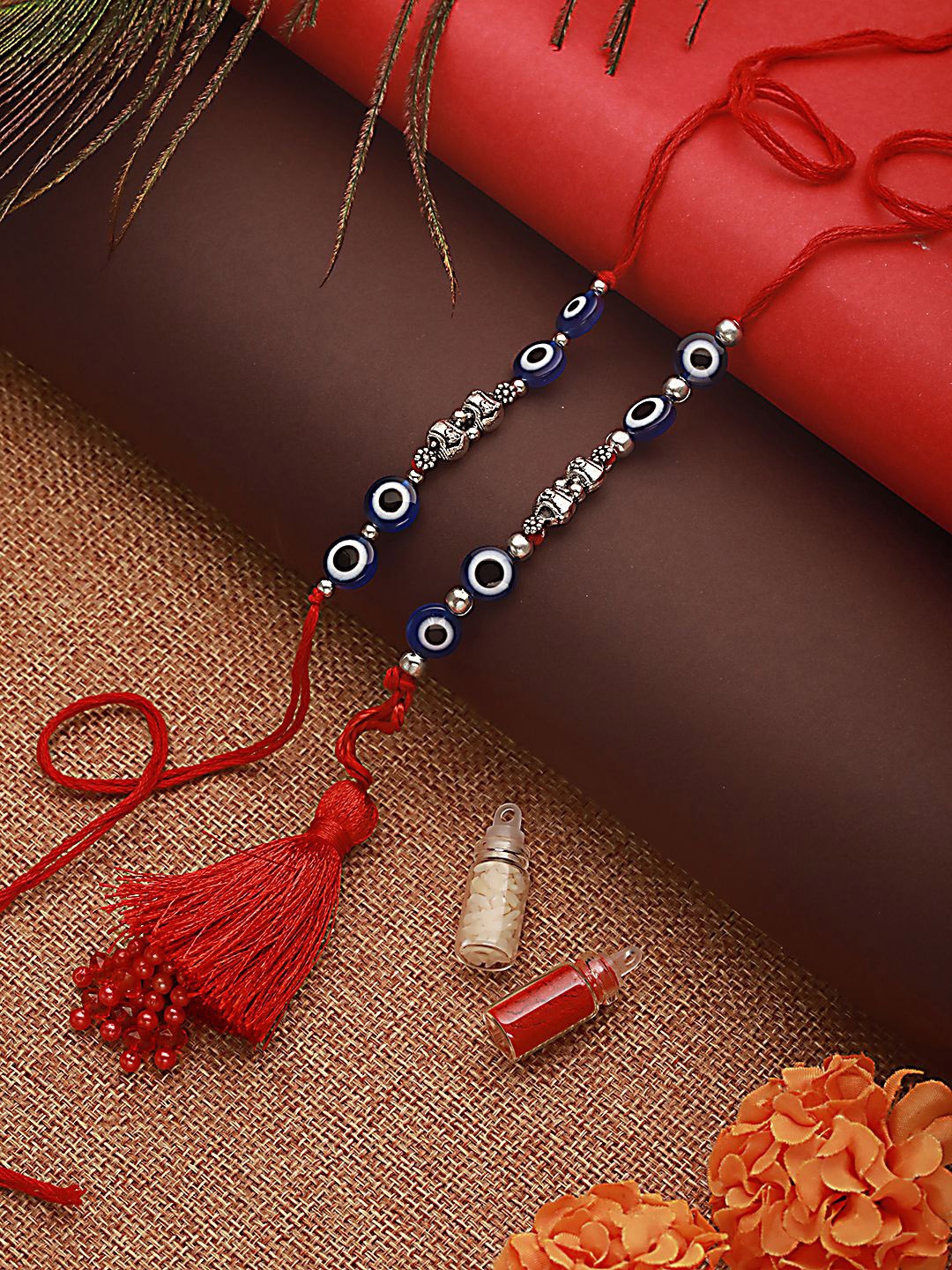 

Jazz and Sizzle Evil Eye Bhaiya Bhabhi Tasselled Rakhi with Roli & Chawal, Blue
