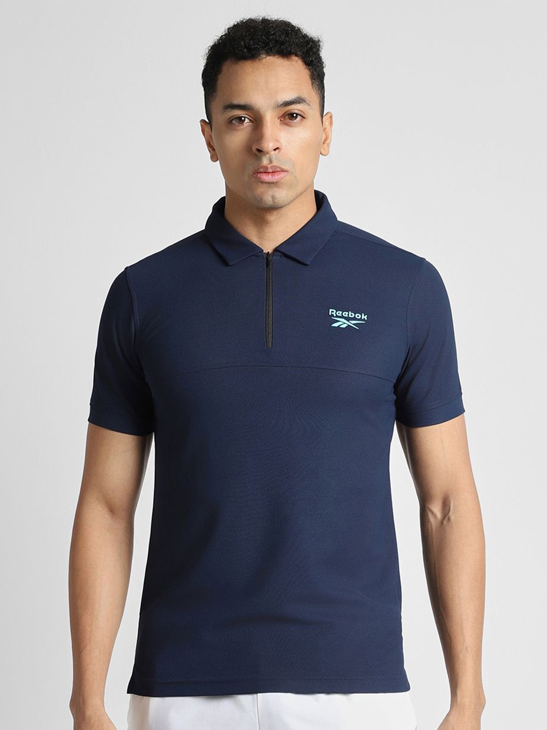 

Reebok Men Solid Polo Collar Slim Fit T-Shirt, Navy blue