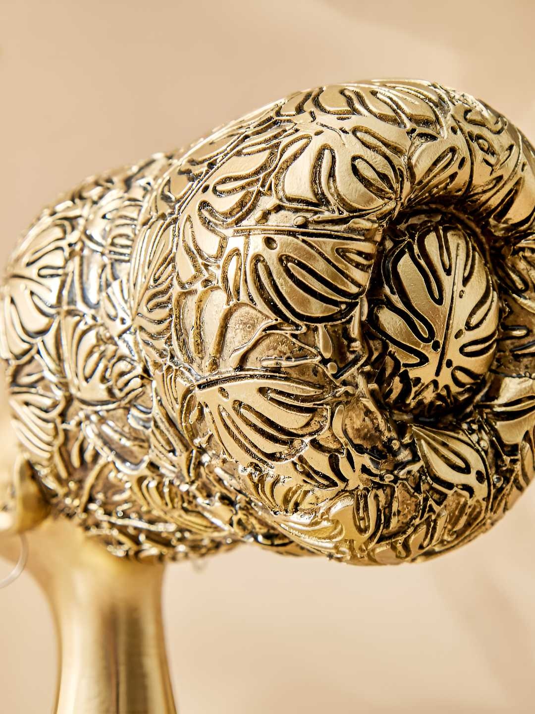 

Home Centre Gold-Toned & Black Textured Figurine Showpiece