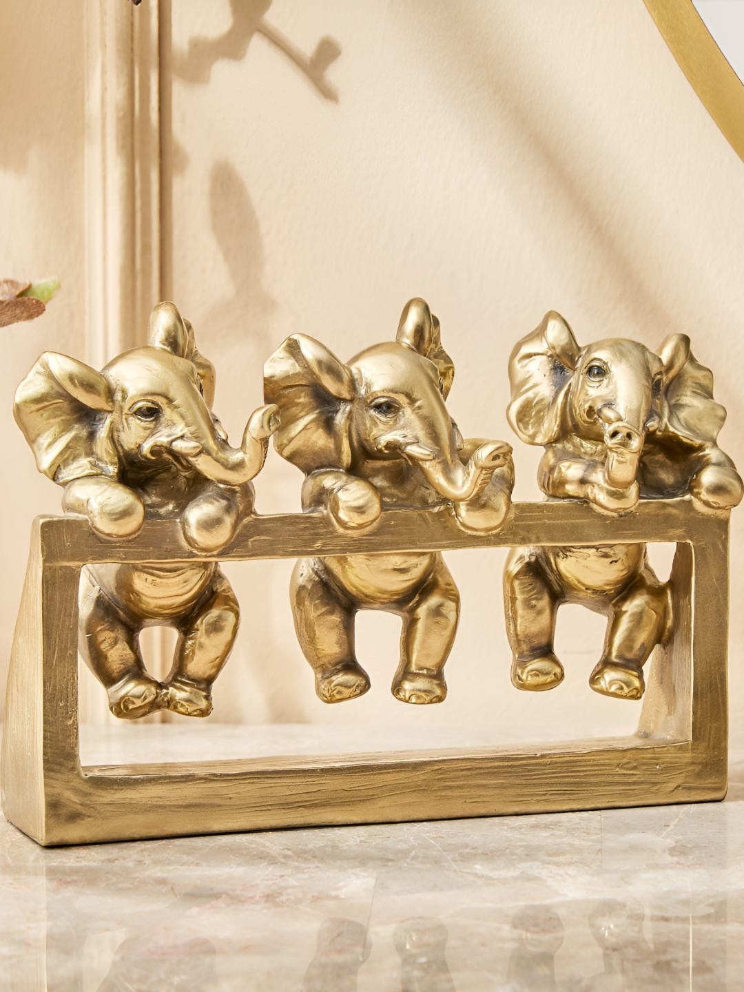 

Home Centre Gold Toned Baby Elephants Figurine Showpiece