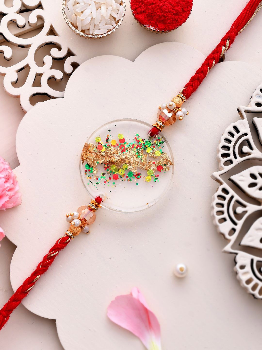 

Aapno Rajasthan Beaded Thread Rakhi with Roli Chawal & Greetings Card, Red