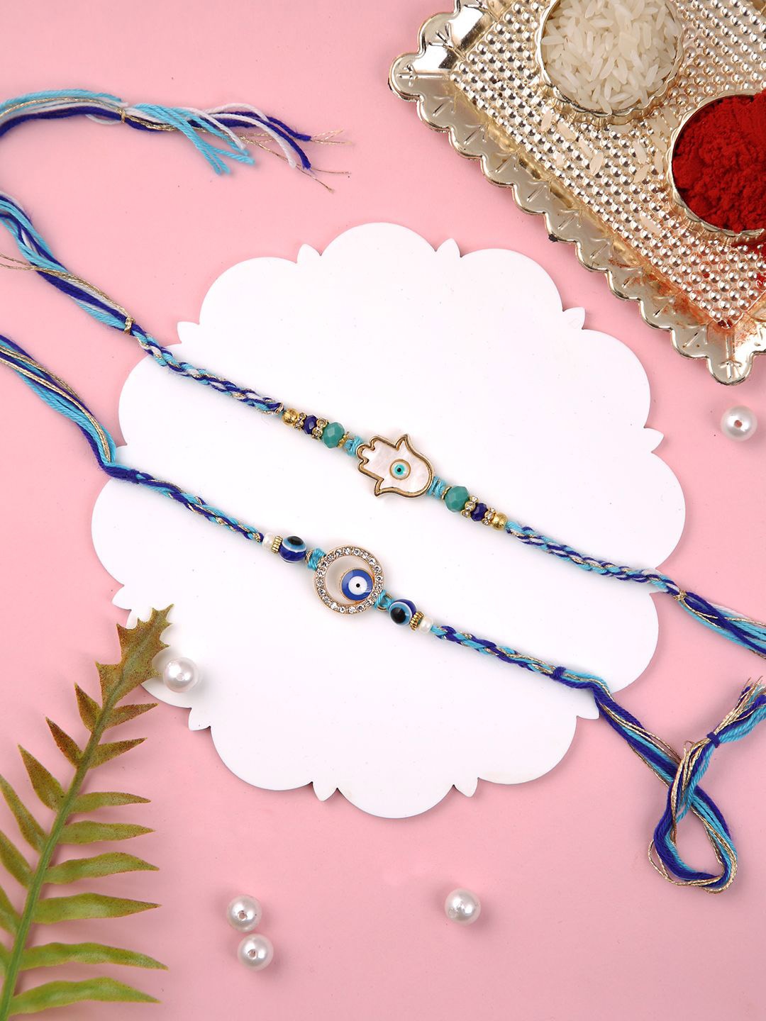 

Aapno Rajasthan Set of 2 Thread Rakhis with Roli Chawal & Greetings Card, Blue