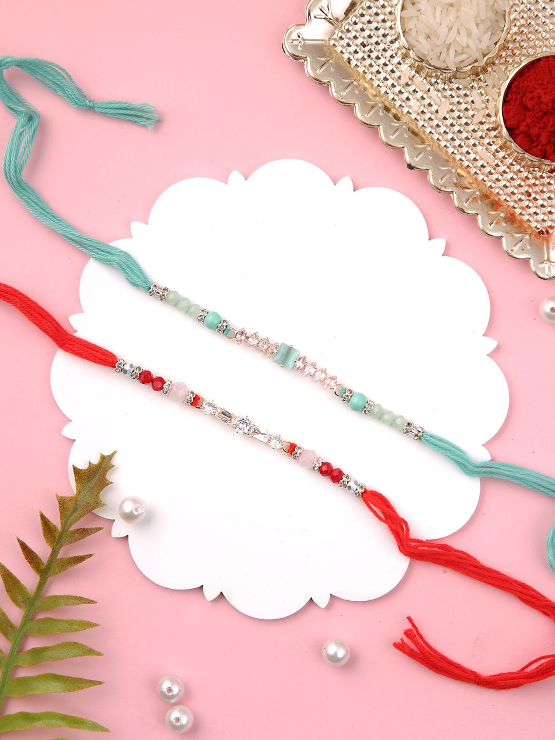 

Aapno Rajasthan Set of 2 Thread Rakhis with Roli Chawal & Greetings Card, Red