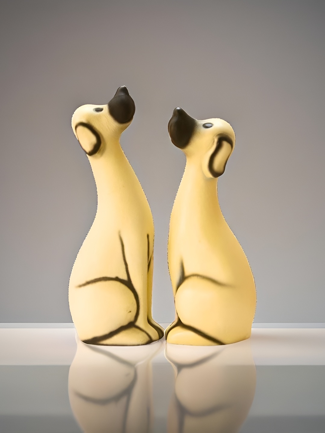 

BECKON VENTURE Beige & Black 2 Pieces Dogs Figurine Showpiece