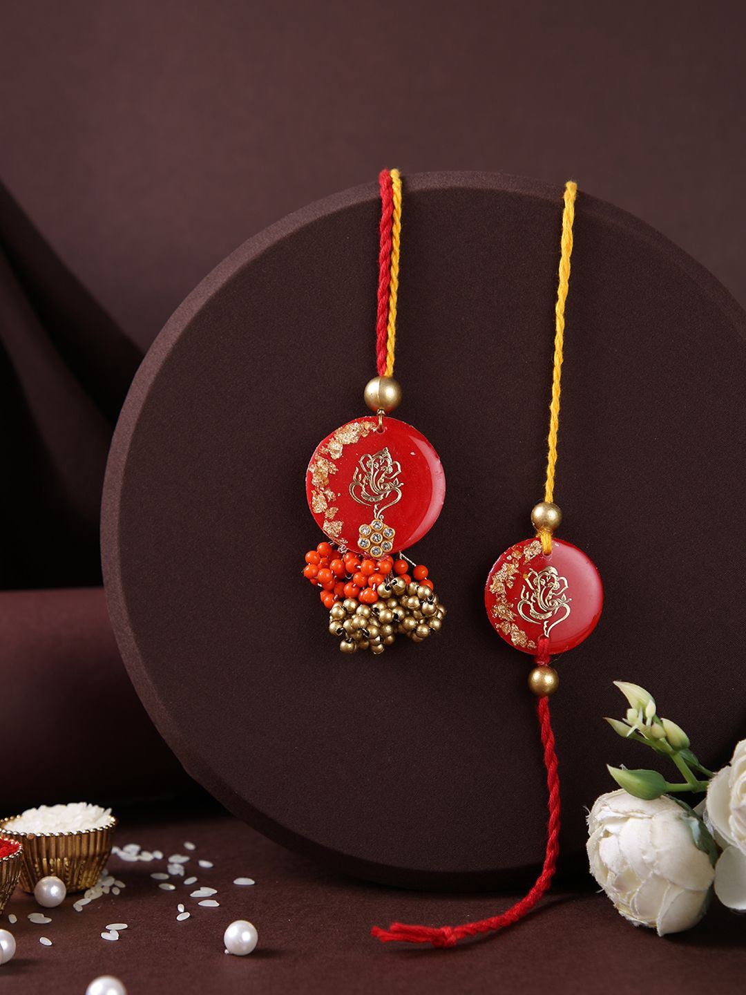 

Aapno Rajasthan Ganesha Resin Work Bhaiya Bhabhi Rakhi With Roli Chawal & Greeting Card, Gold