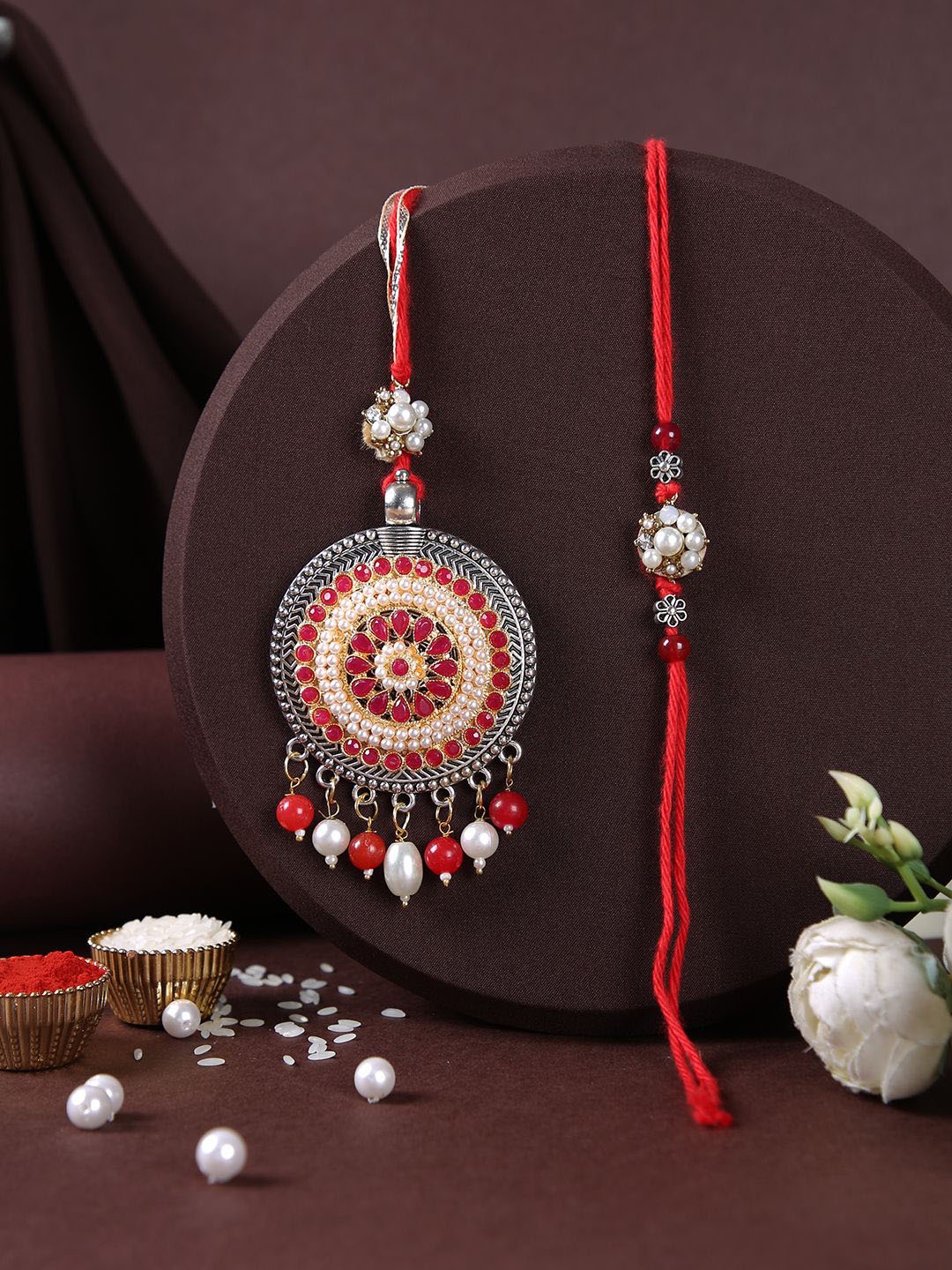 

Aapno Rajasthan Stones Studded Bhaiya Bhabhi Rakhi With Roli Chawal & Greeting Card, Red