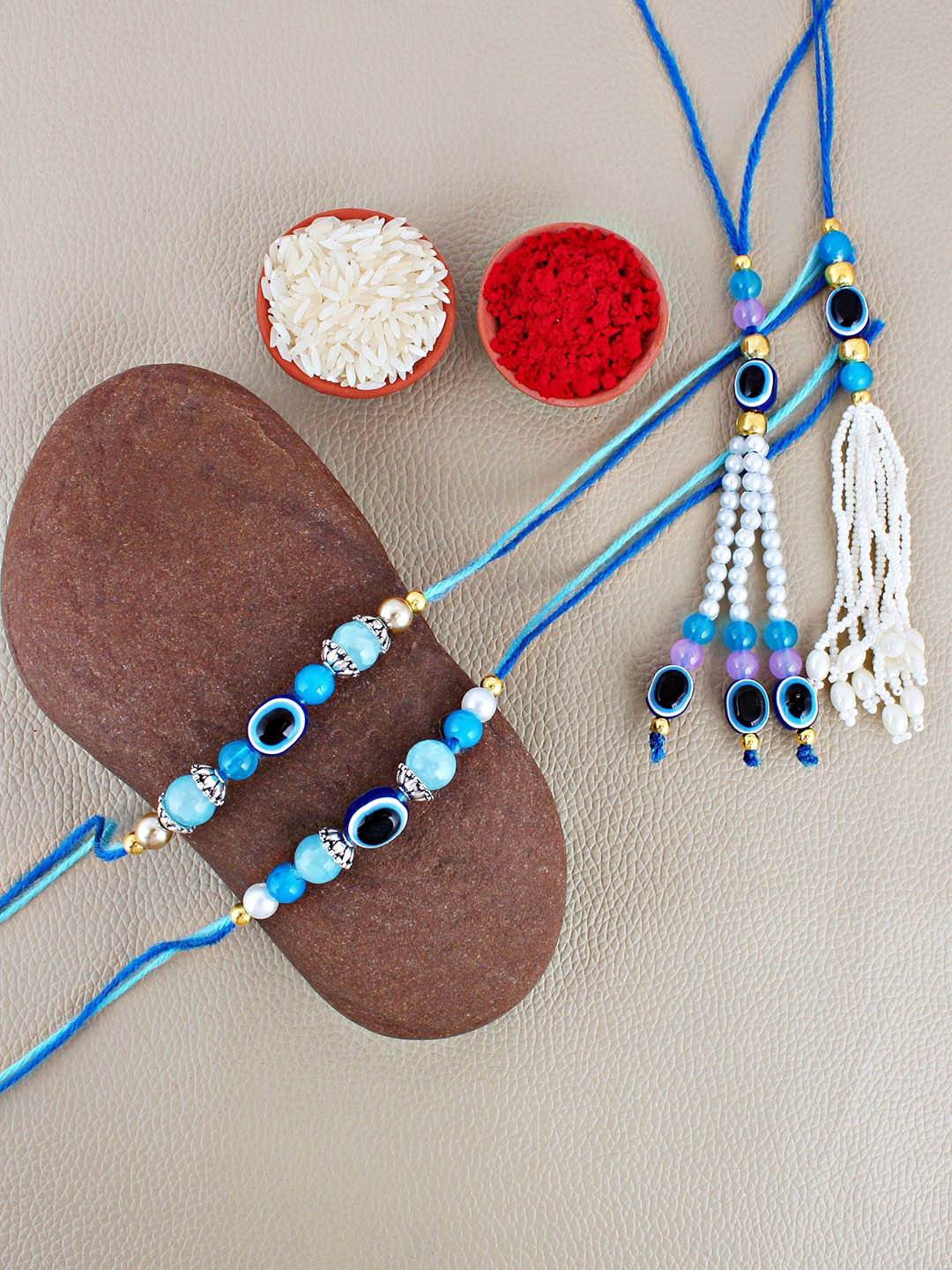 

LUCKY JEWELLERY Set Of 2 Evil Eye Bhaiya Bhabhi Rakhis With Roli Chawal & Greeting Card, Blue
