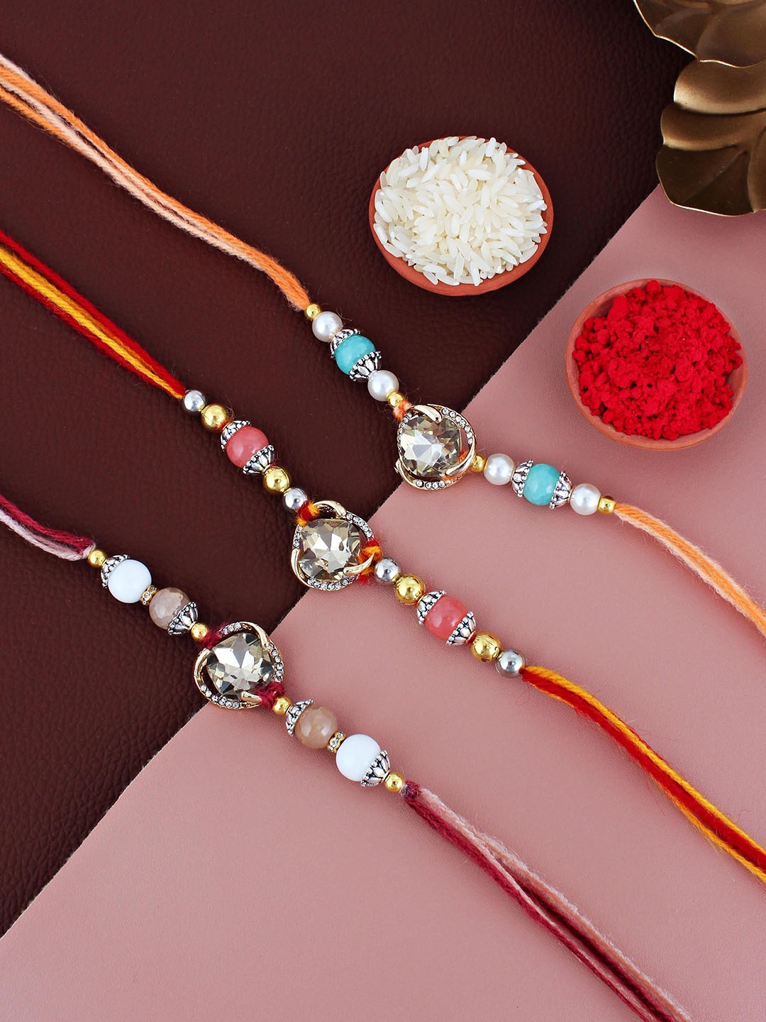 

LUCKY JEWELLERY Set Of 3 Gold Plated Stone-Studded Rakhis With Roli Chawal & Greeting Card