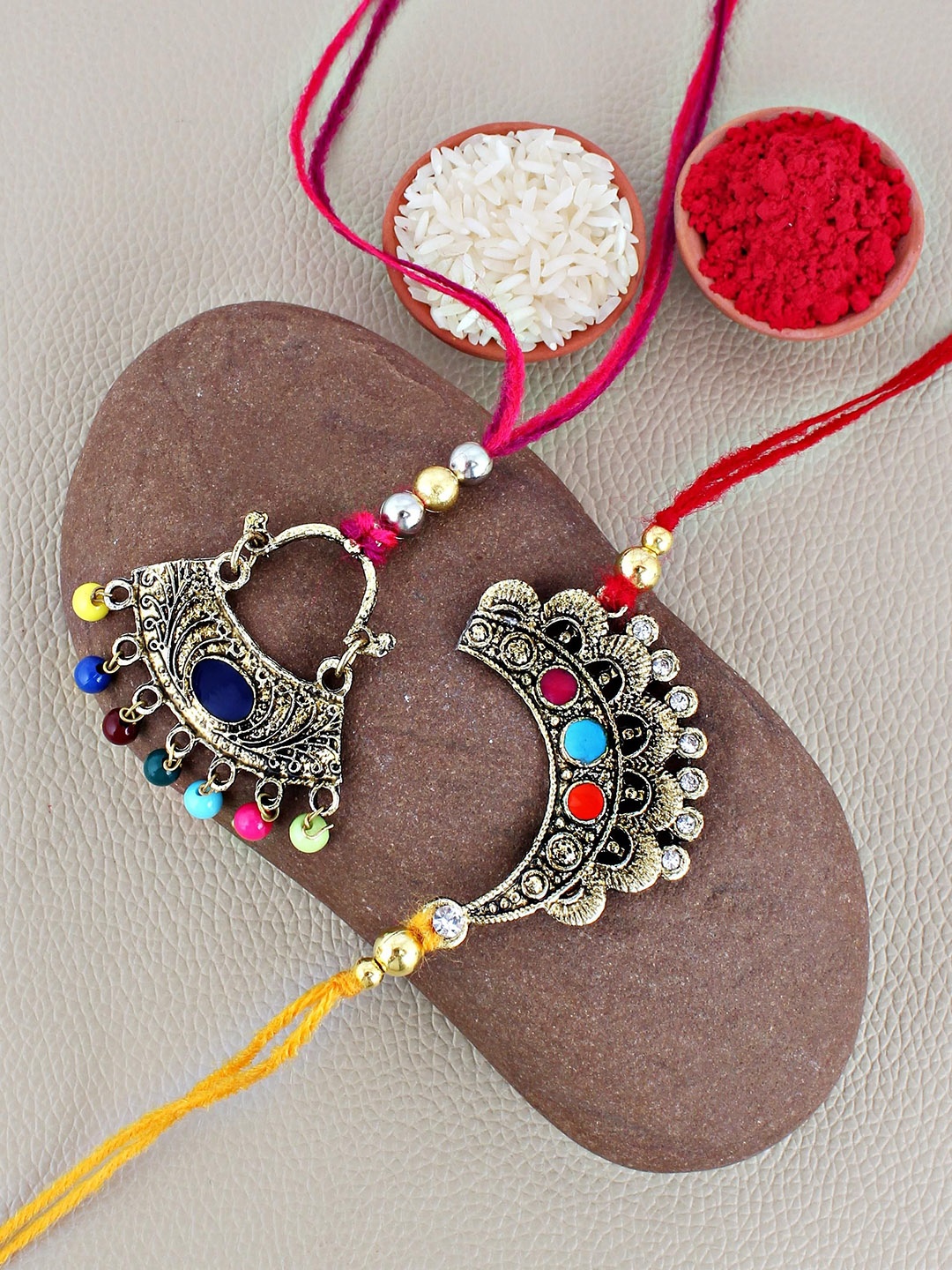 

LUCKY JEWELLERY Set Of 2 Meena Beaded Lumba & Thread Rakhis With Roli Chawal, Gold