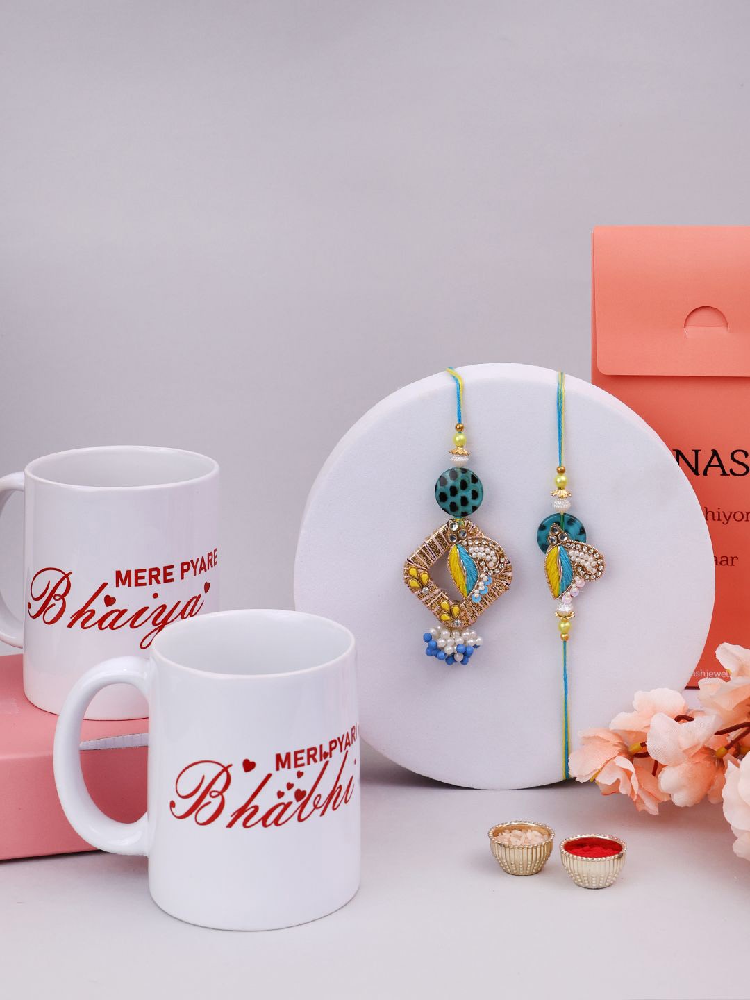 

PANASH Set Of 2 Gold-Plated Beaded & Stone Studded Rakhis & Printed Mugs With Roli Chawal